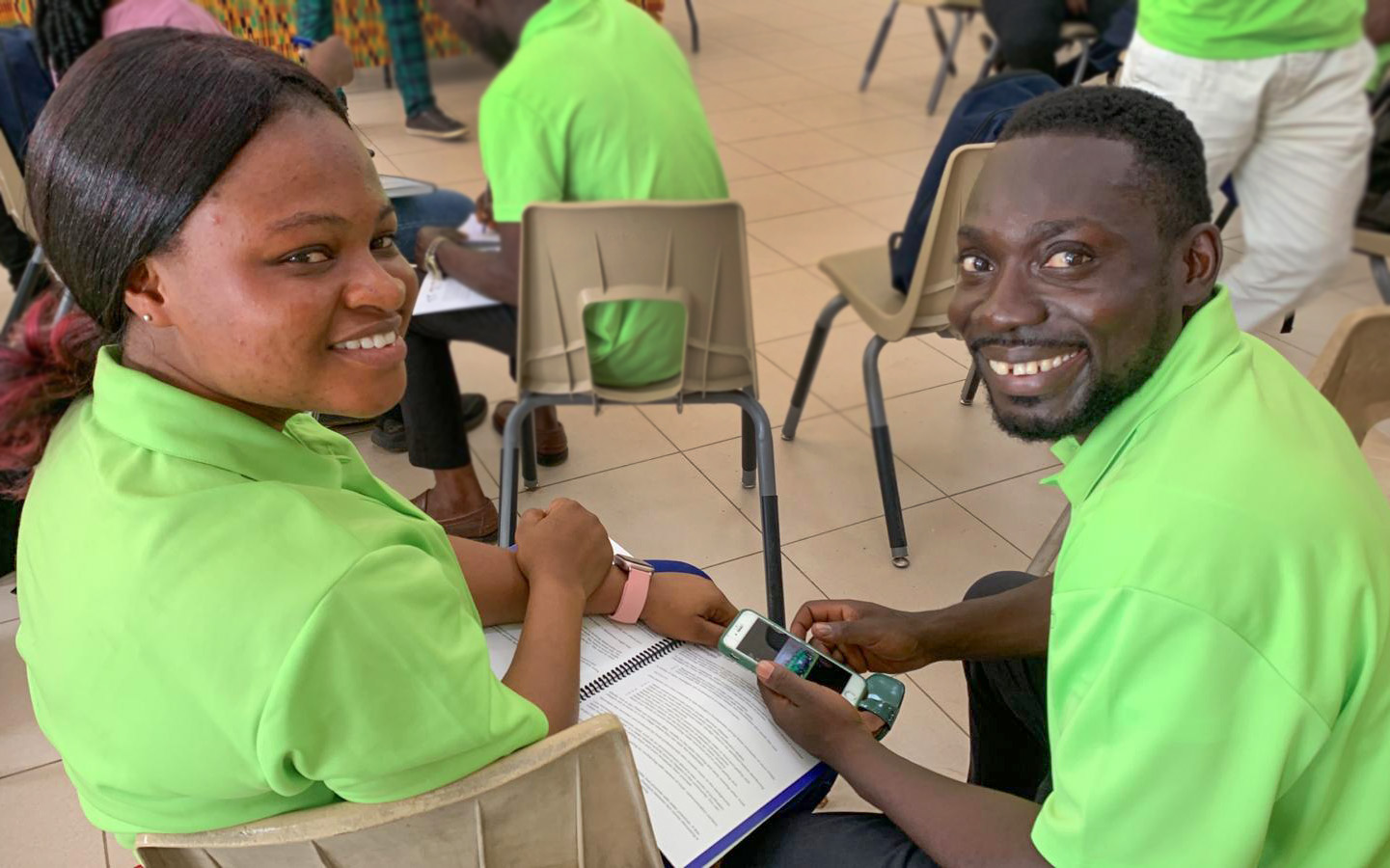 Two Bright Water Safe Water Educators, guy and gal, in green shirts.