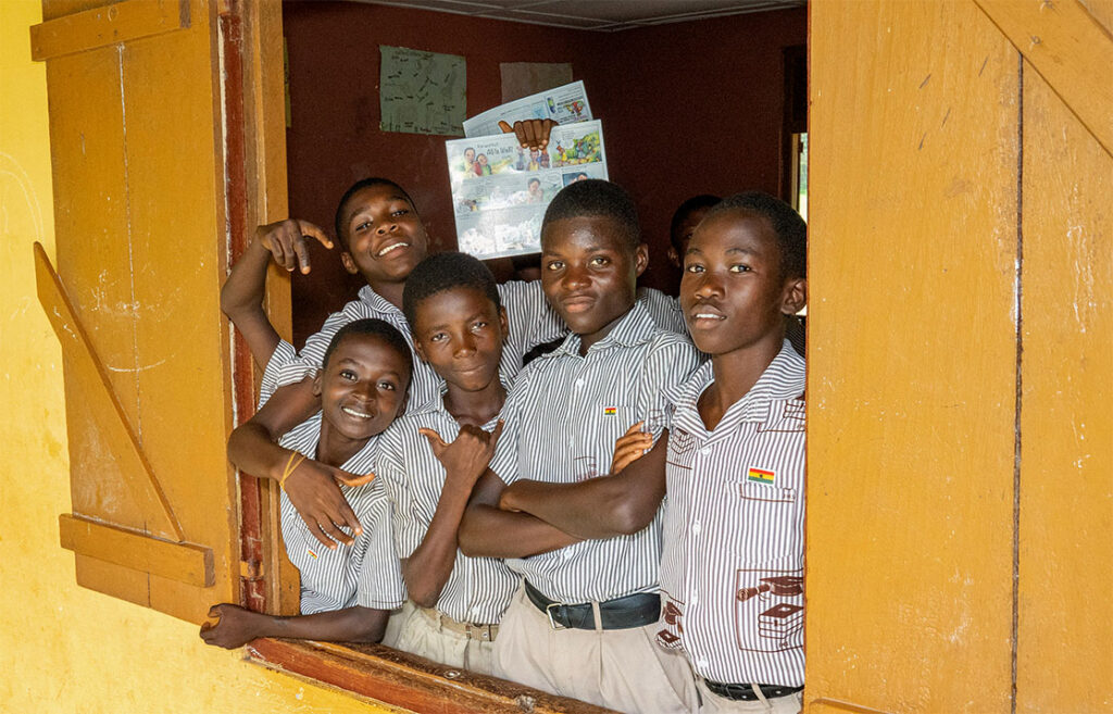 Health club boys at school house window.